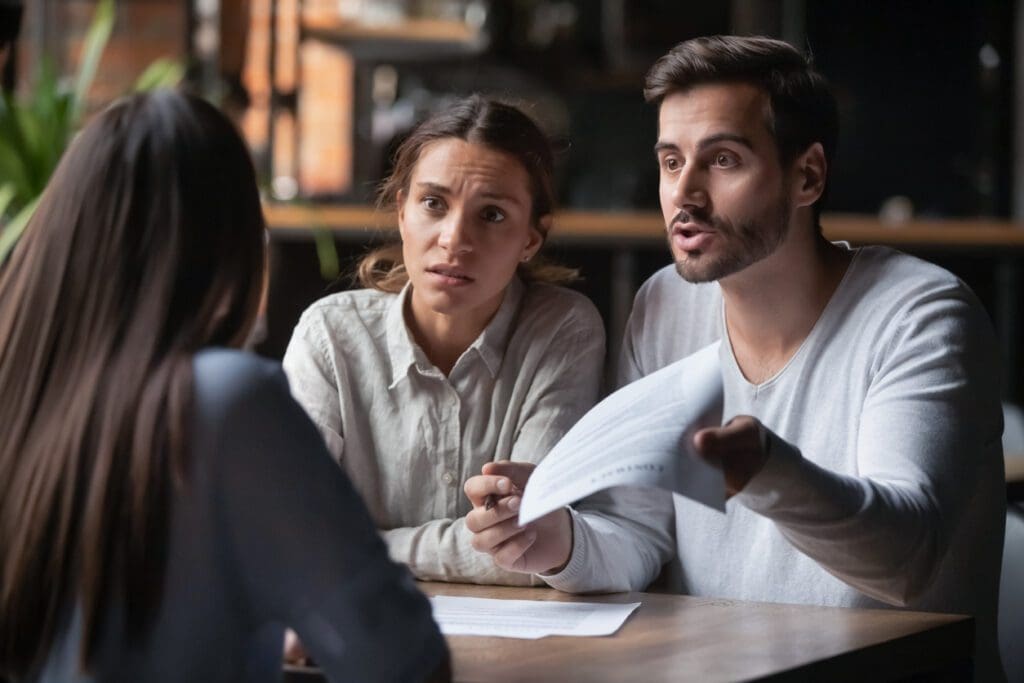 A couple arguing with an insurance provider