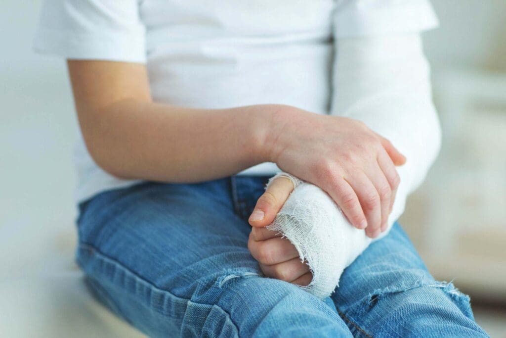 A person with a broken arm, sitting in an attorney's office, asking how are Personal Injury Settlements calculated?