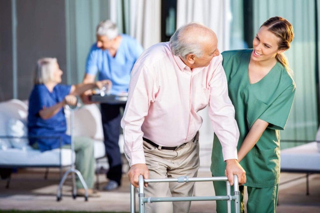 A nurse assist a senior man in walker.