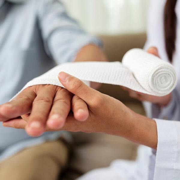 A doctor tending to a patient with burn injuries. An attorney can explain if you can sue for a burn injury. 