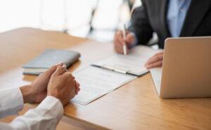 Two lawyers sitting at a desk and working. You can learn more about what a truck accident lawyer does right now.