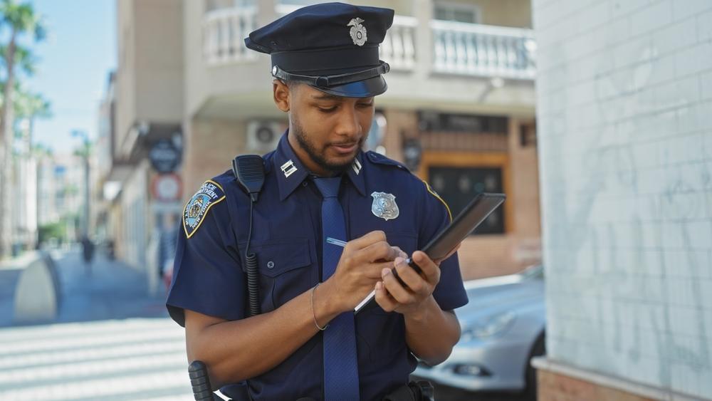 A police officer taking a report after a minor car accident.