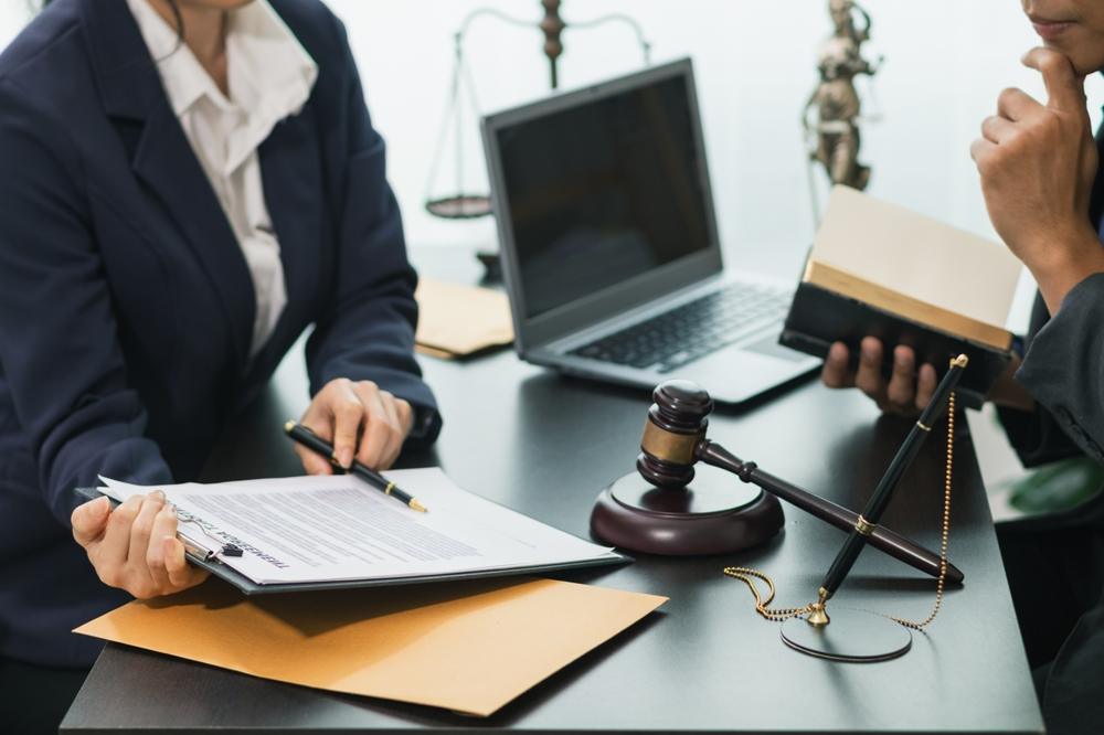 A lawyer showing a client paperwork explaining how long a wrongful death lawsuit takes