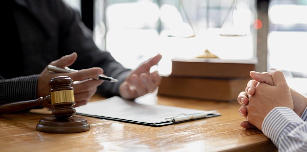 A client consulting a lawyer. Learn about whether wrongful death is civil or criminal.